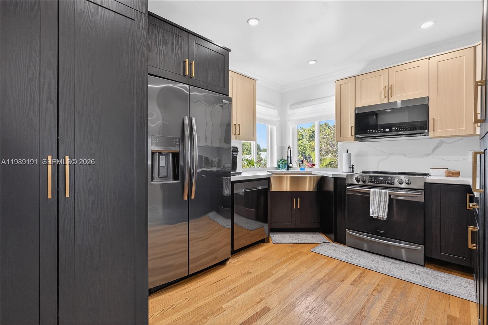 2431 Southwest 4th Street Miami, FL 33135 - Photo 27 of 33 a kitchen with stainless steel appliances a refrigerator sink and microwave