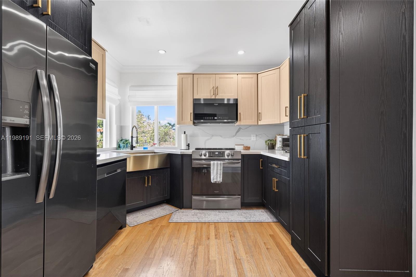 2431 Southwest 4th Street Miami, FL 33135 - Photo 29 of 33 a kitchen with stainless steel appliances granite countertop a refrigerator a stove and a sink