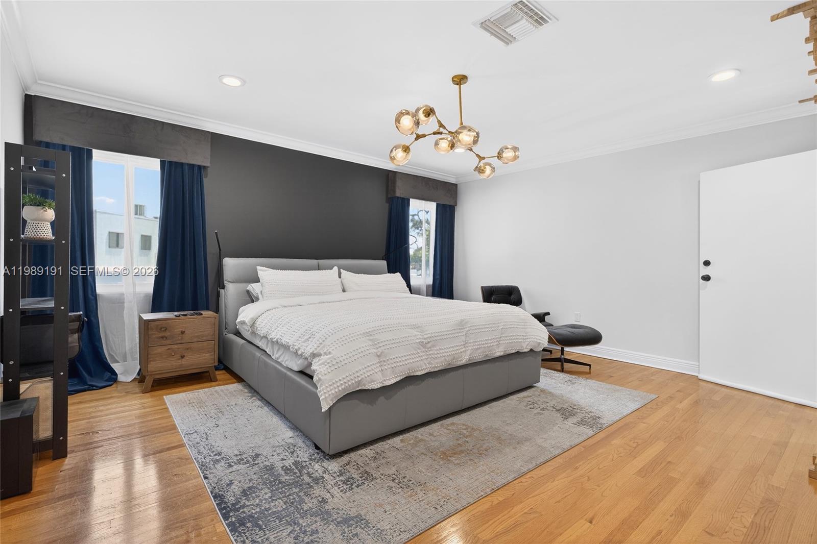 2431 Southwest 4th Street Miami, FL 33135 - Photo 31 of 33 a bedroom with a large bed and a chandelier