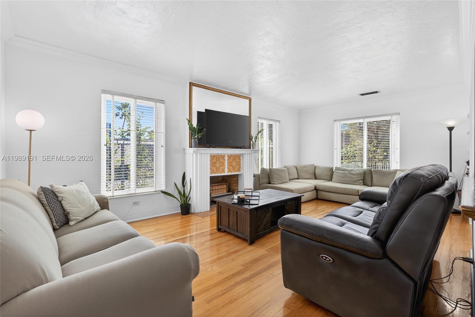 2431 Southwest 4th Street Miami, FL 33135 - Photo 4 of 33 a living room with furniture a flat screen tv and a large window
