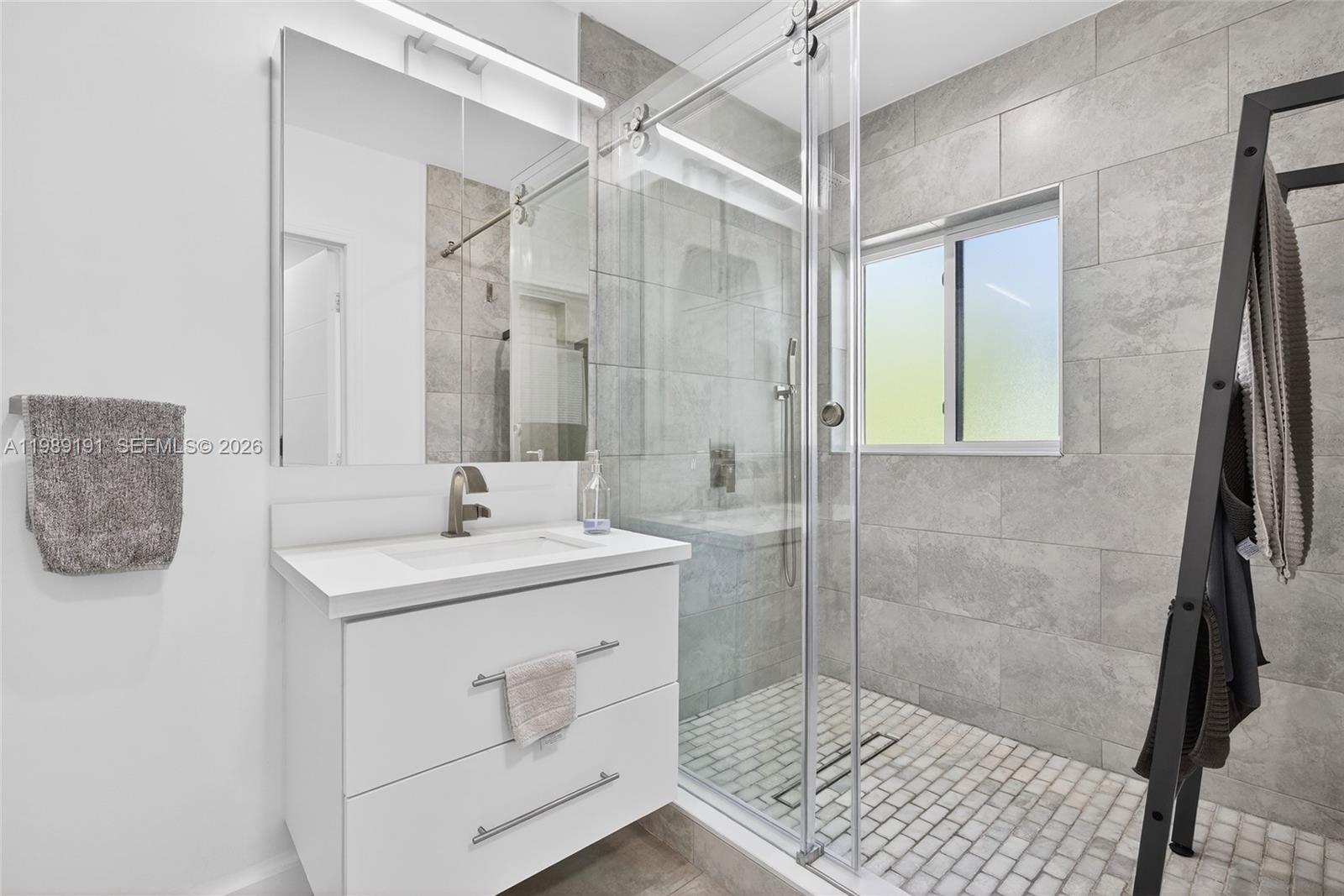 2431 Southwest 4th Street Miami, FL 33135 - Photo 9 of 33 a bathroom with a shower sink and mirror