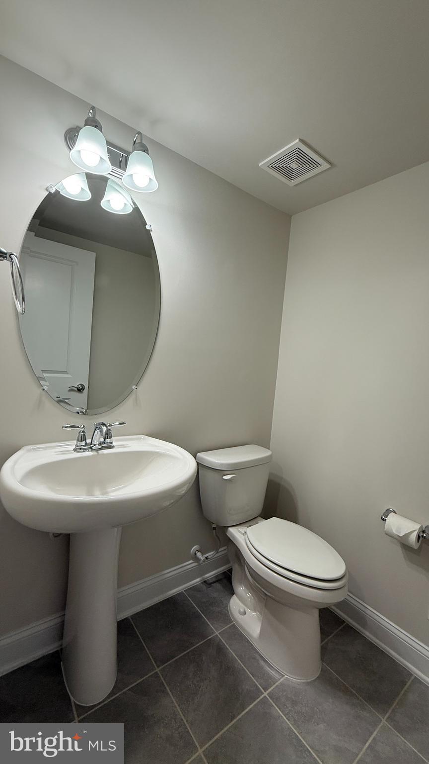 1949 Greenbriar Hall Road Dumfries, VA 22026 - Photo 9 of 26 a bathroom with a sink toilet and a mirror