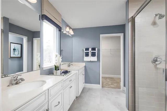 a spacious bathroom with a double vanity sink mirror and double