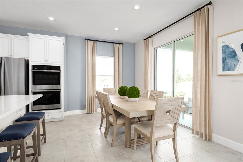4641 Spire Run Lakewood Ranch, FL 34211 - Photo 3 of 21 a view of a dining room with furniture and a window