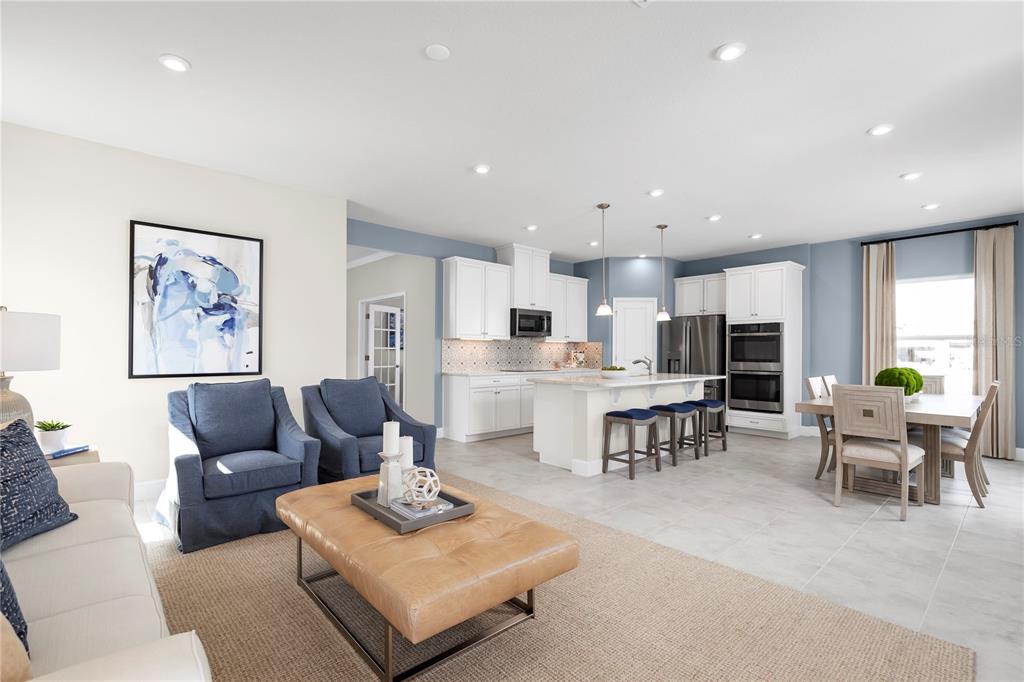 4641 Spire Run Lakewood Ranch, FL 34211 - Photo 6 of 21 a living room with furniture kitchen view and a dining table