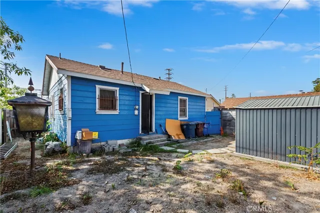 a view of a house with wooden fence