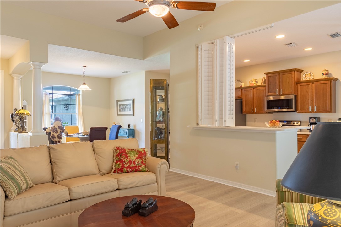 671 Gossamer Wing Way Sebastian, FL 32958 - Photo 11 of 36 a living room with furniture and a chandelier