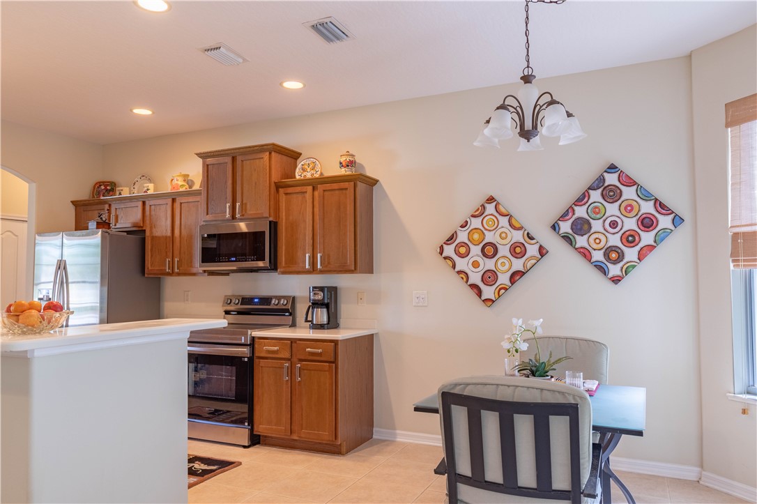 671 Gossamer Wing Way Sebastian, FL 32958 - Photo 14 of 36 a room with furniture a chandelier and a view of kitchen