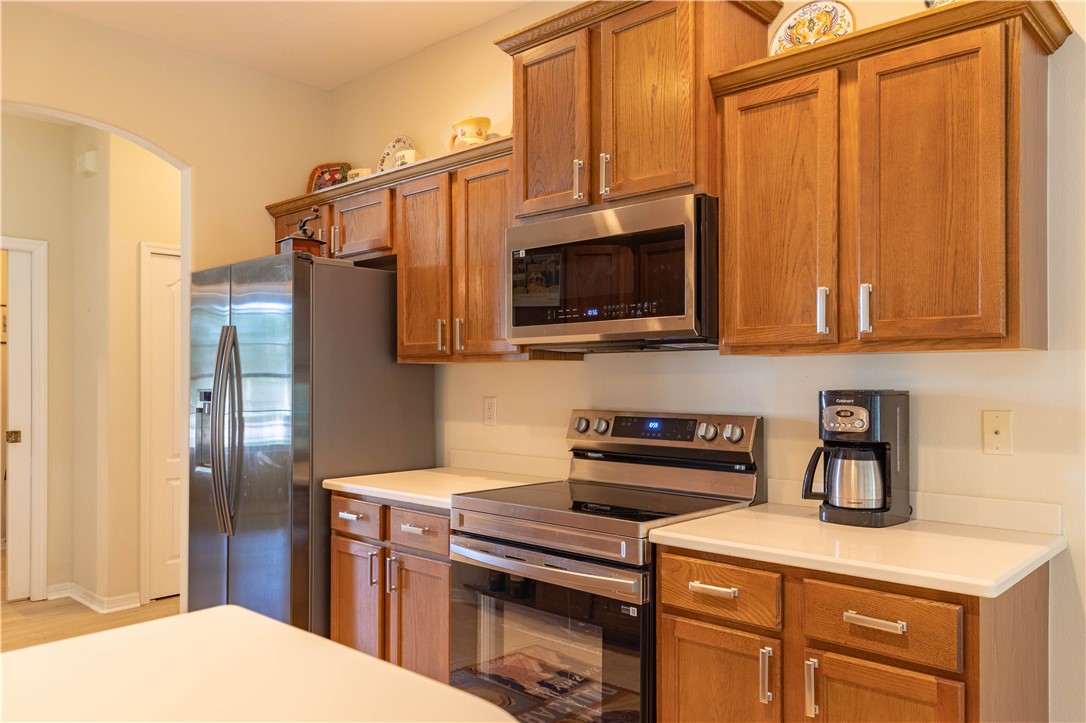 671 Gossamer Wing Way Sebastian, FL 32958 - Photo 15 of 36 a kitchen with stainless steel appliances granite countertop a refrigerator microwave and sink