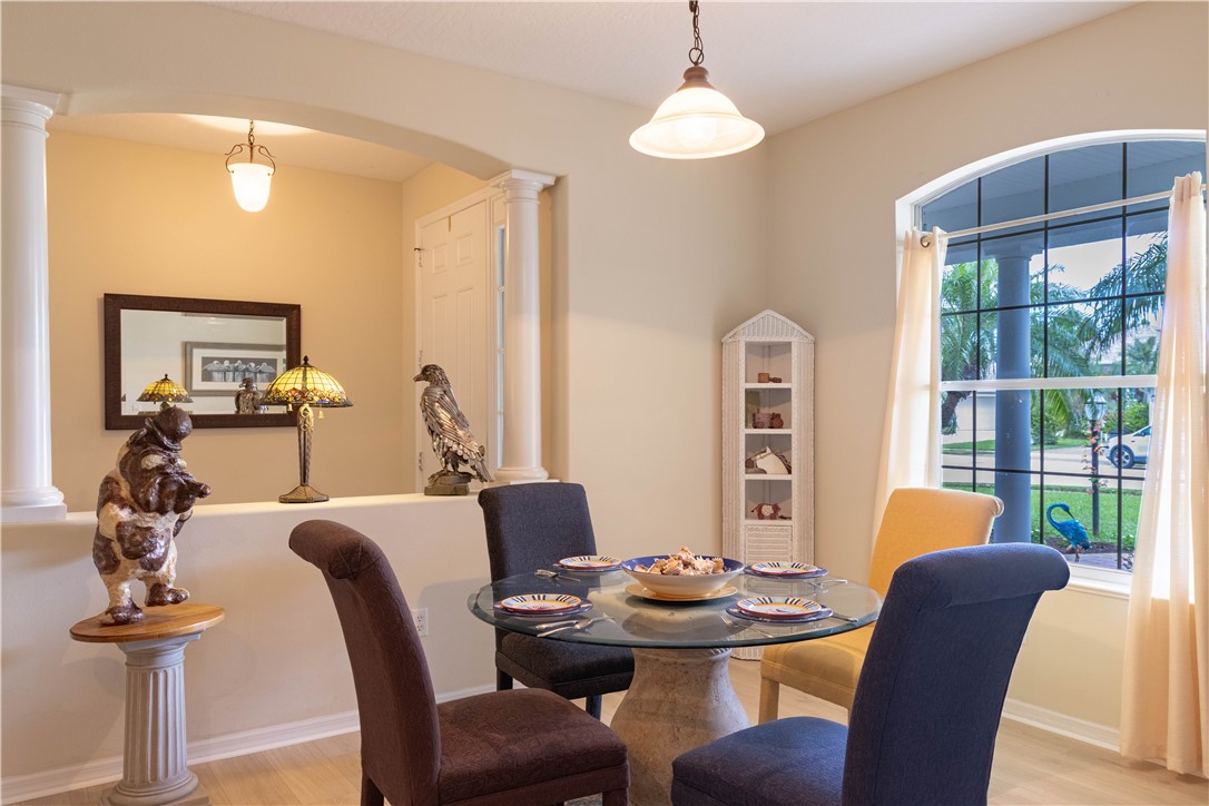 671 Gossamer Wing Way Sebastian, FL 32958 - Photo 17 of 36 a view of a dining room with furniture wooden floor and chandelier