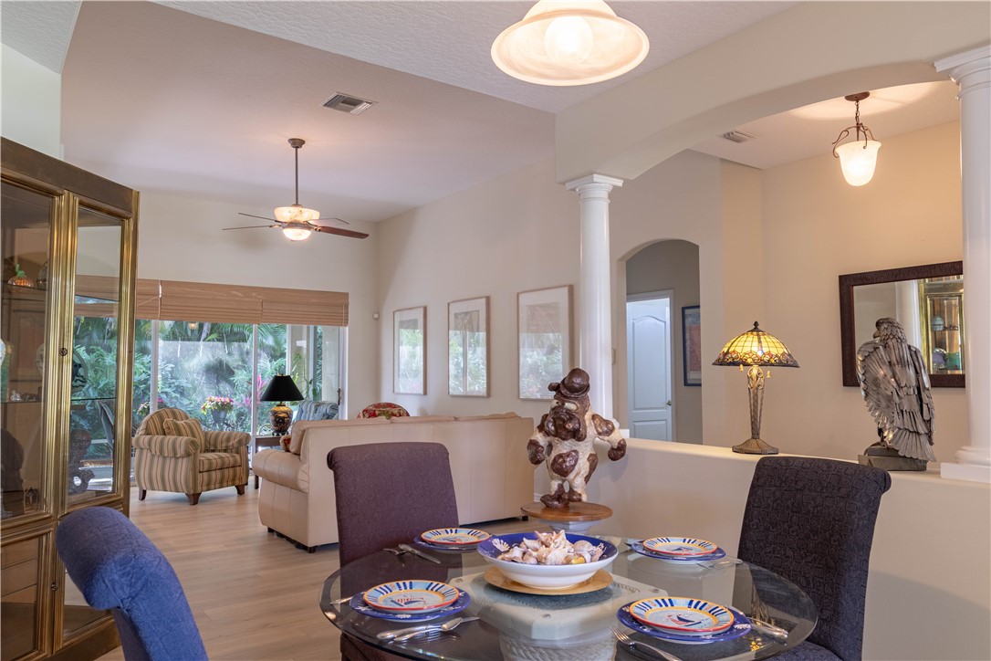 671 Gossamer Wing Way Sebastian, FL 32958 - Photo 18 of 36 a living room with furniture kitchen view and large windows