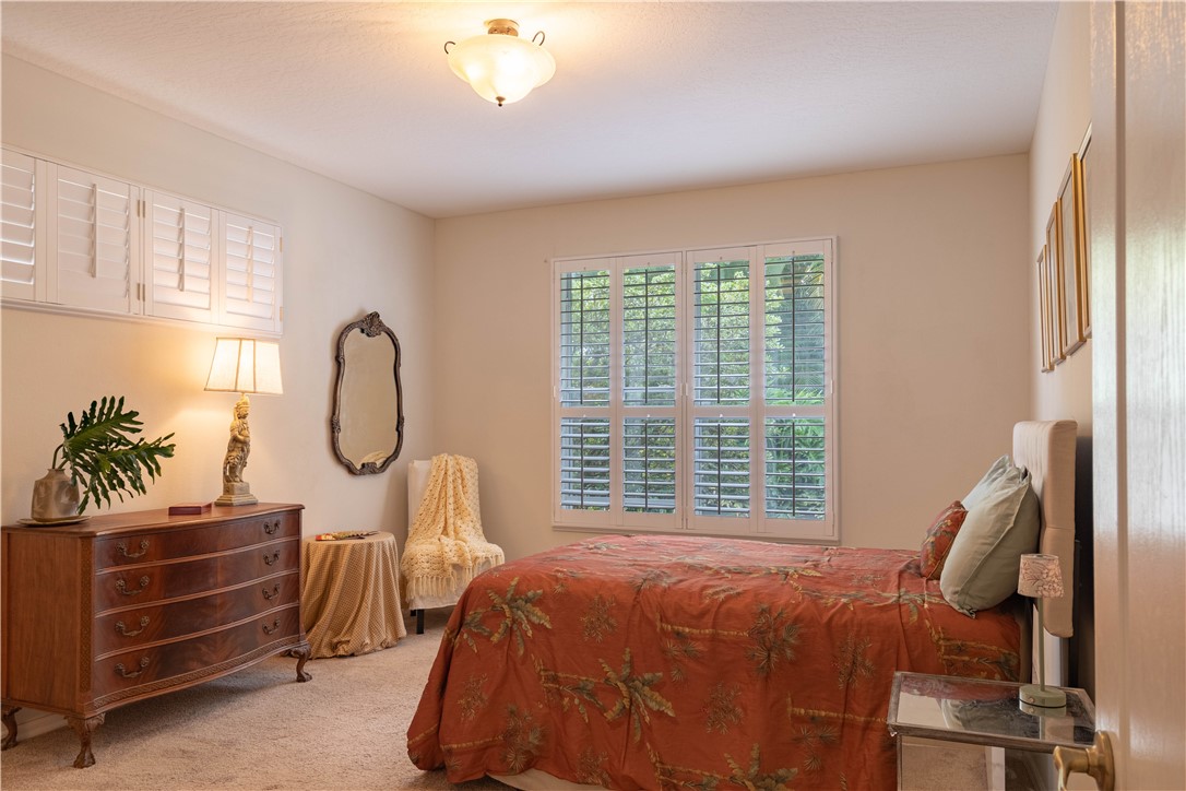 671 Gossamer Wing Way Sebastian, FL 32958 - Photo 20 of 36 a bedroom with a bed a chandelier and a window