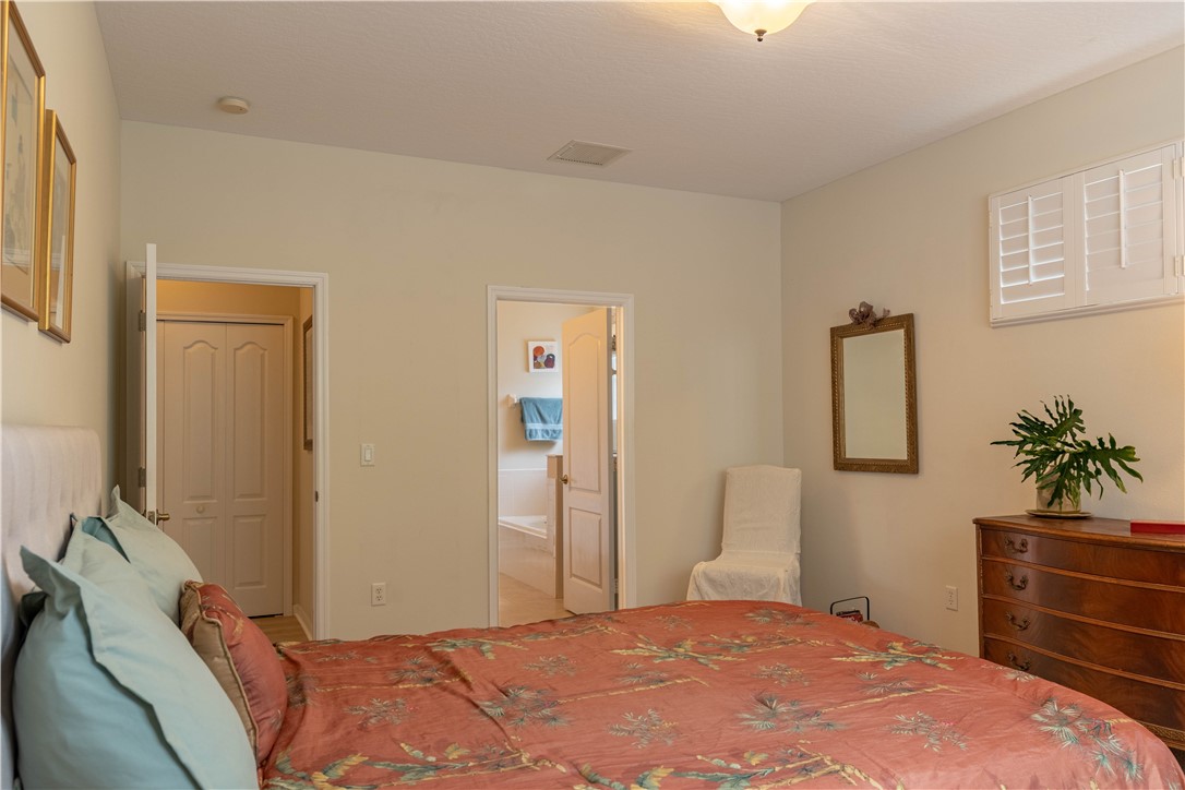 671 Gossamer Wing Way Sebastian, FL 32958 - Photo 22 of 36 a bedroom with a bed and a dresser