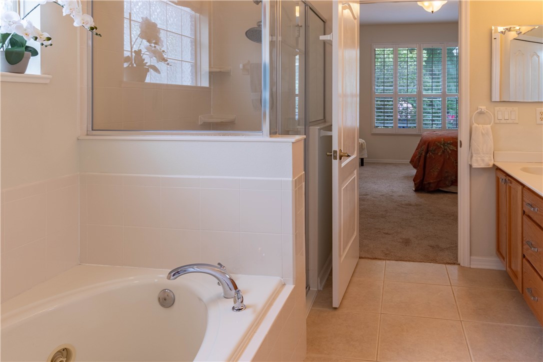 671 Gossamer Wing Way Sebastian, FL 32958 - Photo 25 of 36 a bathroom with a tub sink and glass door