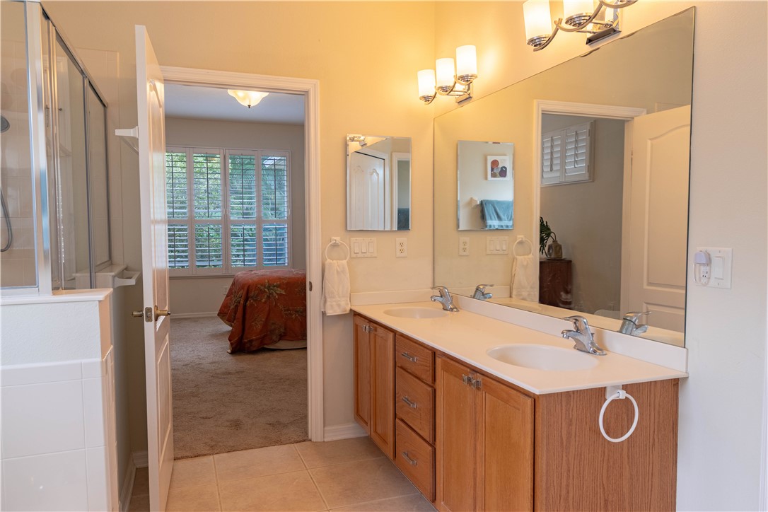 671 Gossamer Wing Way Sebastian, FL 32958 - Photo 28 of 36 a en suite bathroom with a sink and a mirror