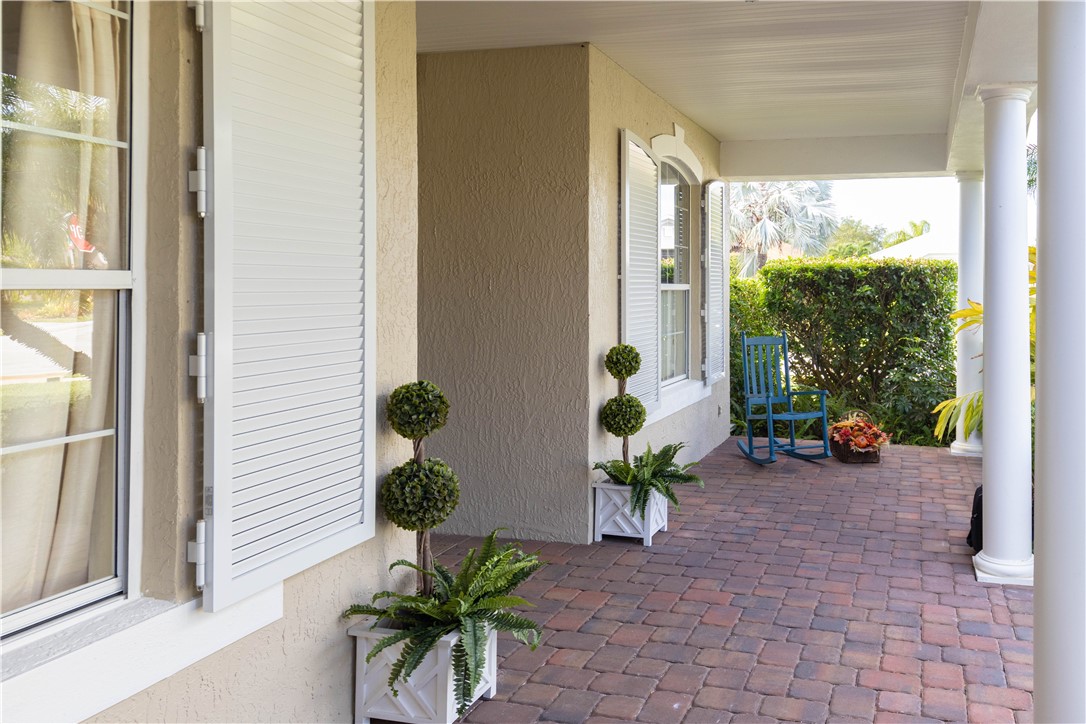 671 Gossamer Wing Way Sebastian, FL 32958 - Photo 29 of 36 a view of a porch with chairs and potted plants