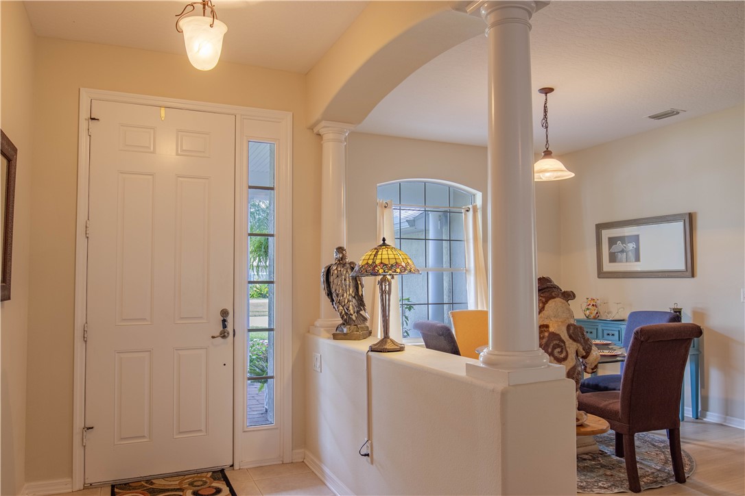 671 Gossamer Wing Way Sebastian, FL 32958 - Photo 8 of 36 a view of a dining room with furniture and a chandelier