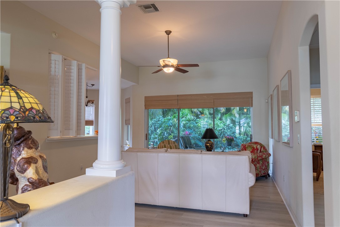 671 Gossamer Wing Way Sebastian, FL 32958 - Photo 9 of 36 a living room with large window and chandelier