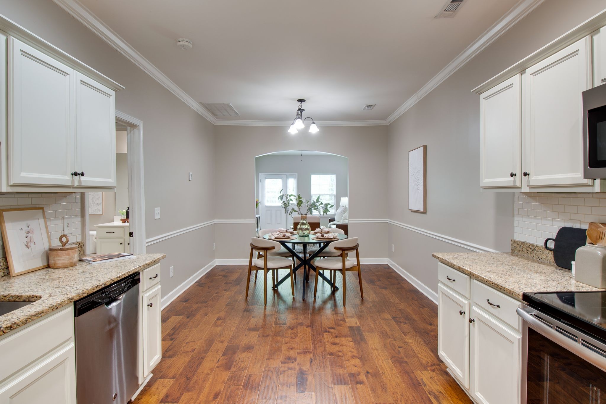 149 Velena Street Franklin, TN 37064 - Photo 14 of 27 a dining room with wooden floor a chandelier a wooden table and chairs