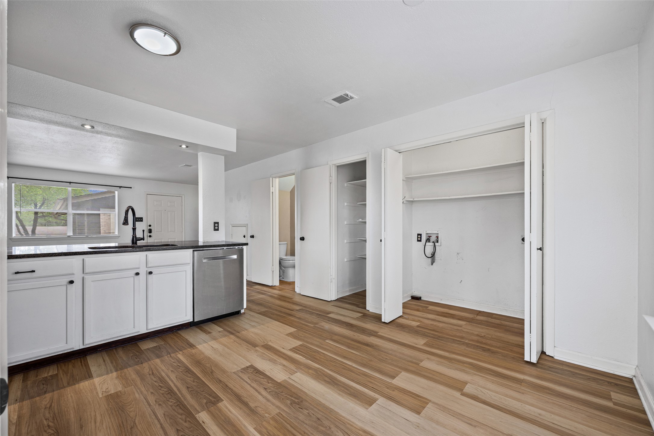8100 Dunn Street, Unit B Austin, TX 78745 - Photo 13 of 29 a spacious bathroom with a granite countertop sink and a mirror