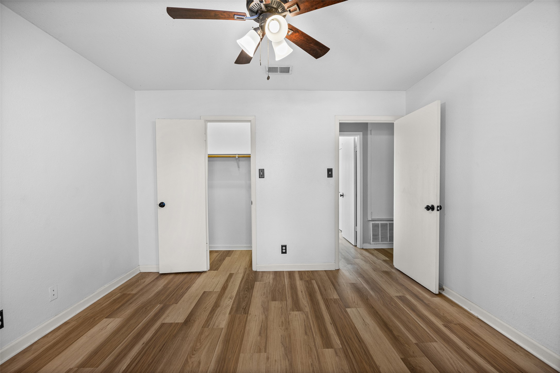 8100 Dunn Street, Unit B Austin, TX 78745 - Photo 17 of 29 a view of a room with wooden floor ceiling fan