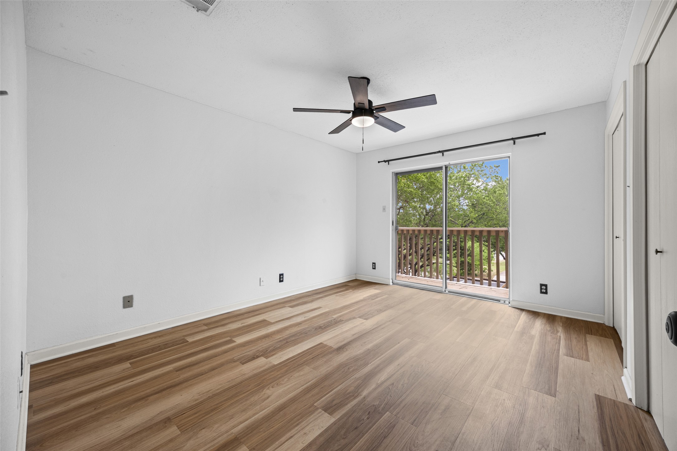 8100 Dunn Street, Unit B Austin, TX 78745 - Photo 19 of 29 an empty room with wooden floor and windows