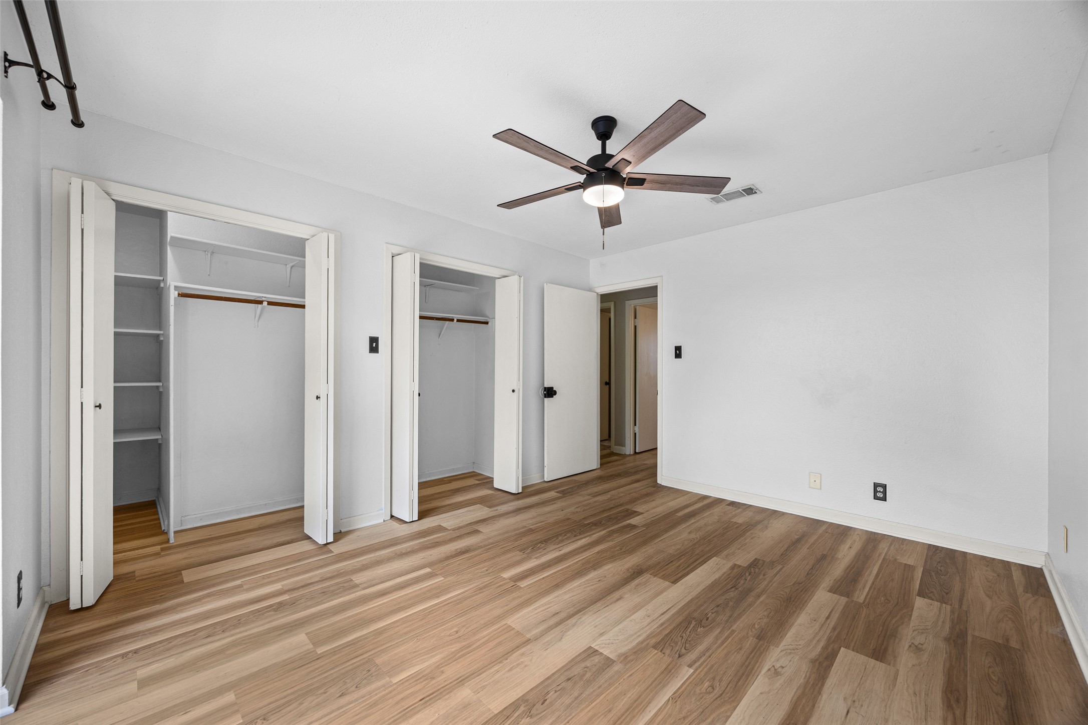 8100 Dunn Street, Unit B Austin, TX 78745 - Photo 21 of 29 a view of empty room with wooden floor and fan