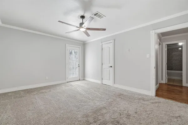 a view of an empty room with a fan