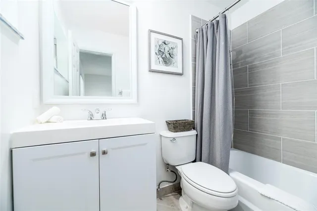a bathroom with a toilet sink and shower