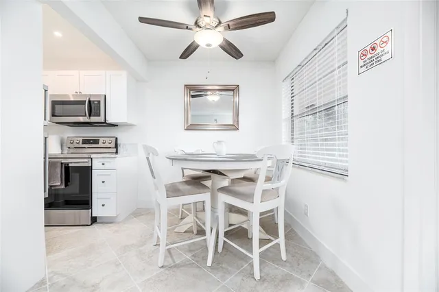 a dining room with furniture and window