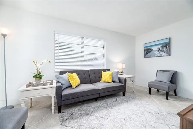 a living room with furniture and white walls