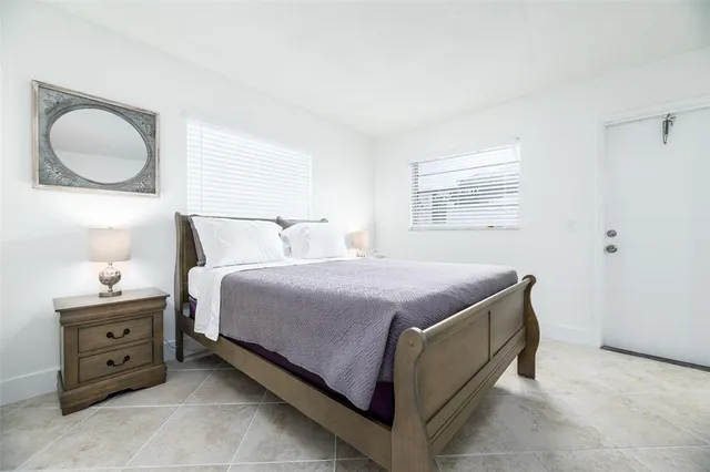 a bedroom with a bed and cabinet