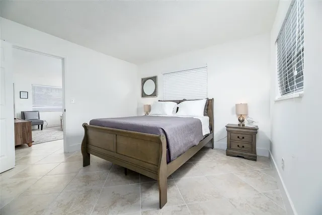 a bedroom with a bed and a couch