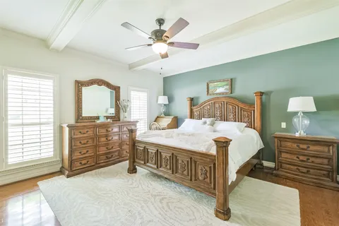 a bedroom with a large bed and a chandelier