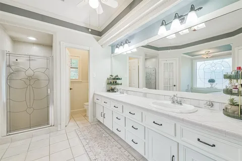 a bathroom with a granite countertop sink mirror and shower