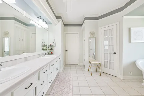 a spacious bathroom with double vanity and a shower