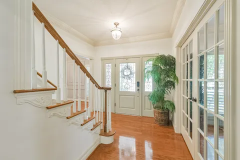 a view of entryway and hall with wooden floor