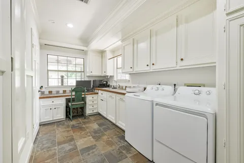 a kitchen with sink cabinets and window