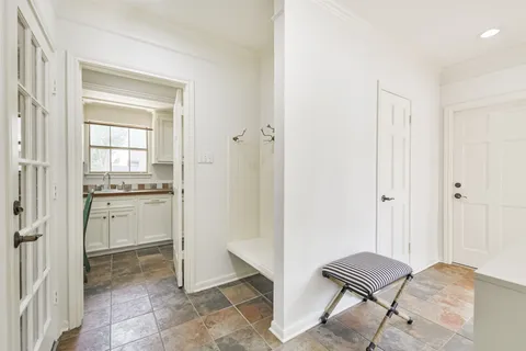 a view of kitchen with white cabinets and stove