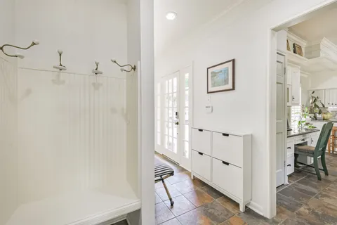 a view of a hallway with closet and windows