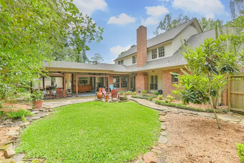 a front view of a house with swimming pool having outdoor seating