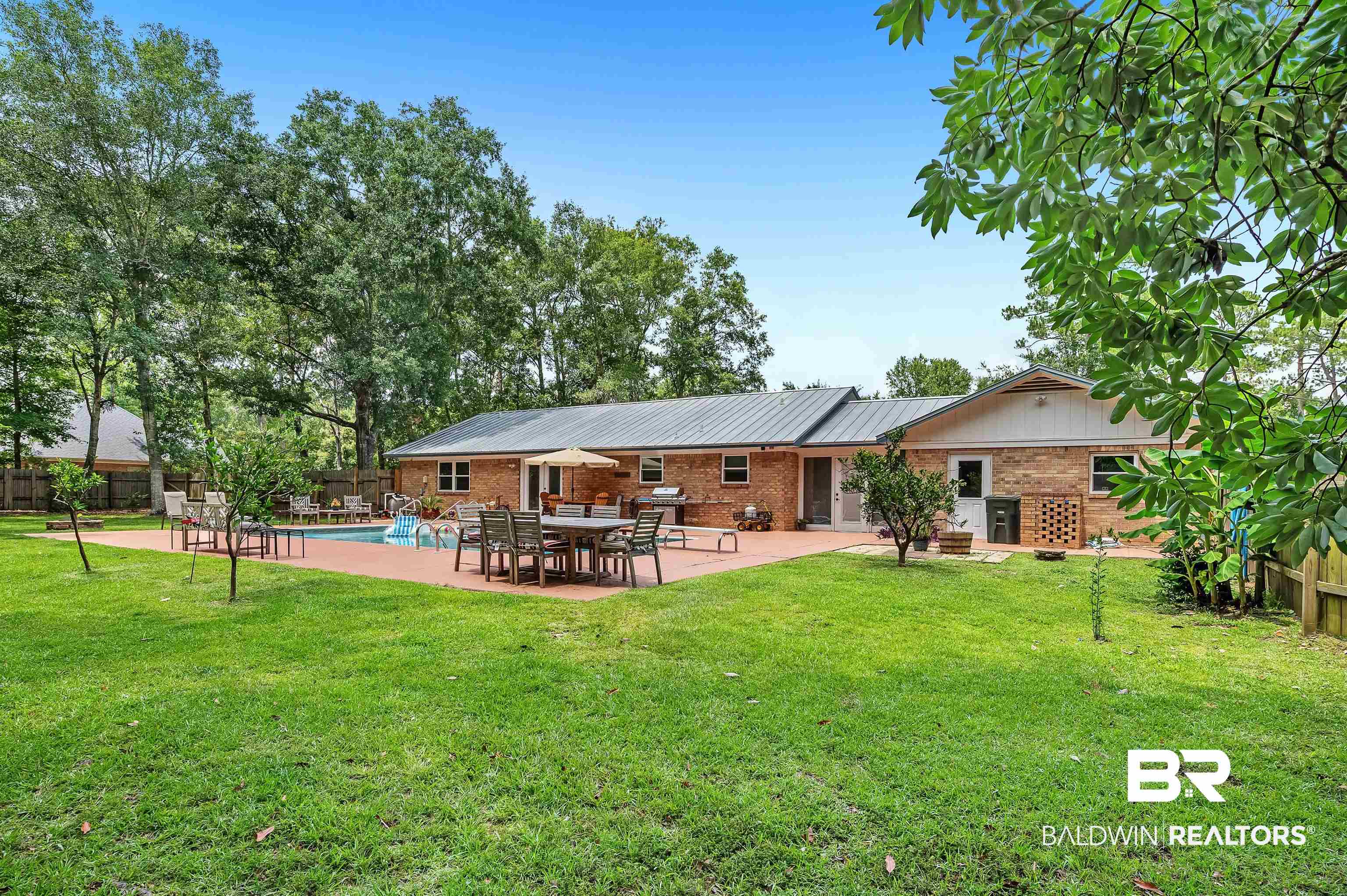 24551 Wolf Bay Drive Foley, AL 36535 - Photo 16 of 59 Rear view of property with brick siding, a fenced backyard, and a patio area