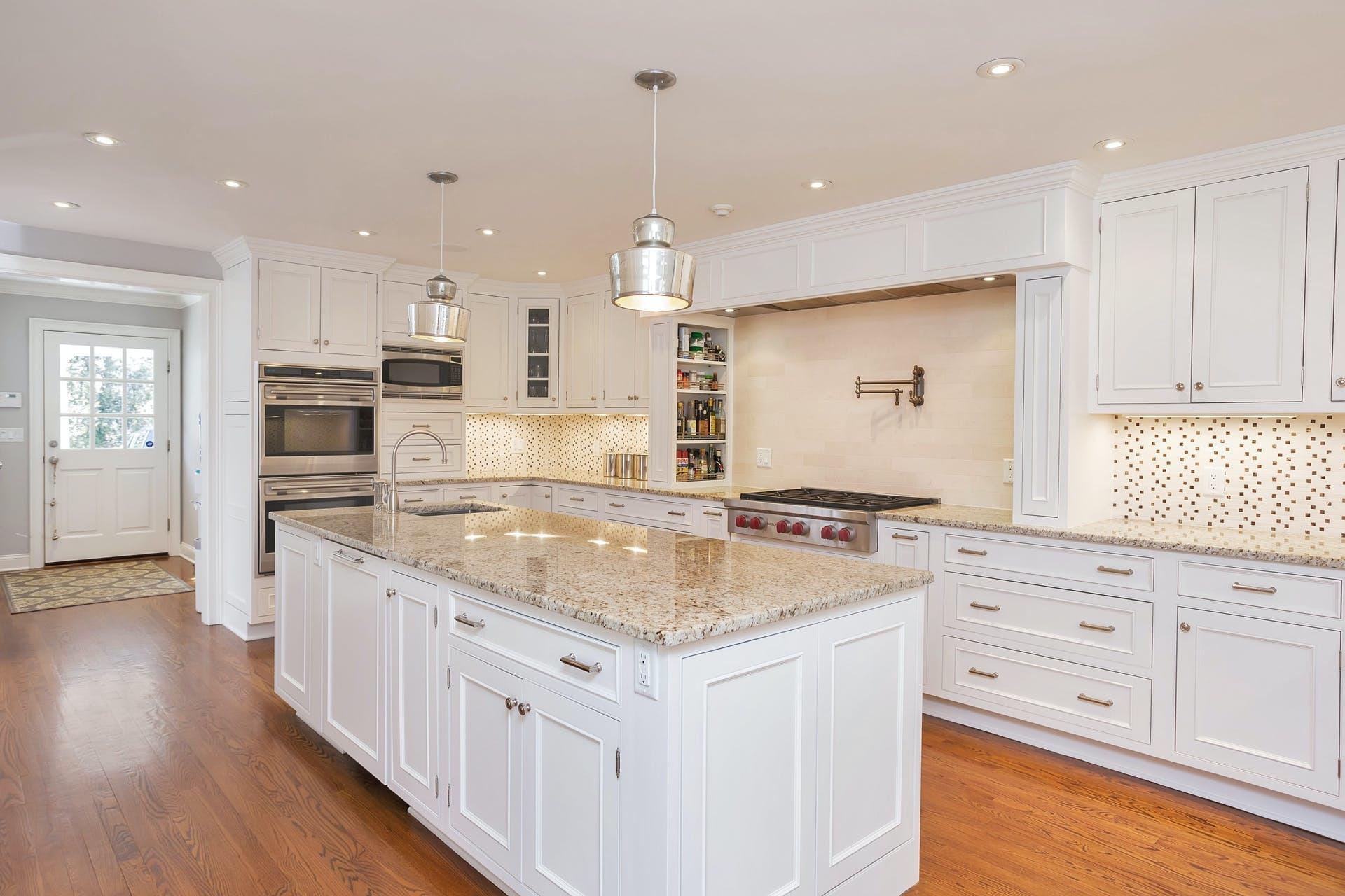 100 Stephen Mather Road Darien, CT 06820 - Photo 11 of 38 a kitchen with granite countertop white cabinets and white appliances