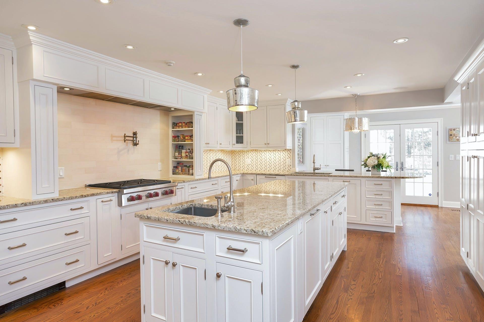 100 Stephen Mather Road Darien, CT 06820 - Photo 13 of 38 a kitchen with kitchen island granite countertop white cabinets and stainless steel appliances
