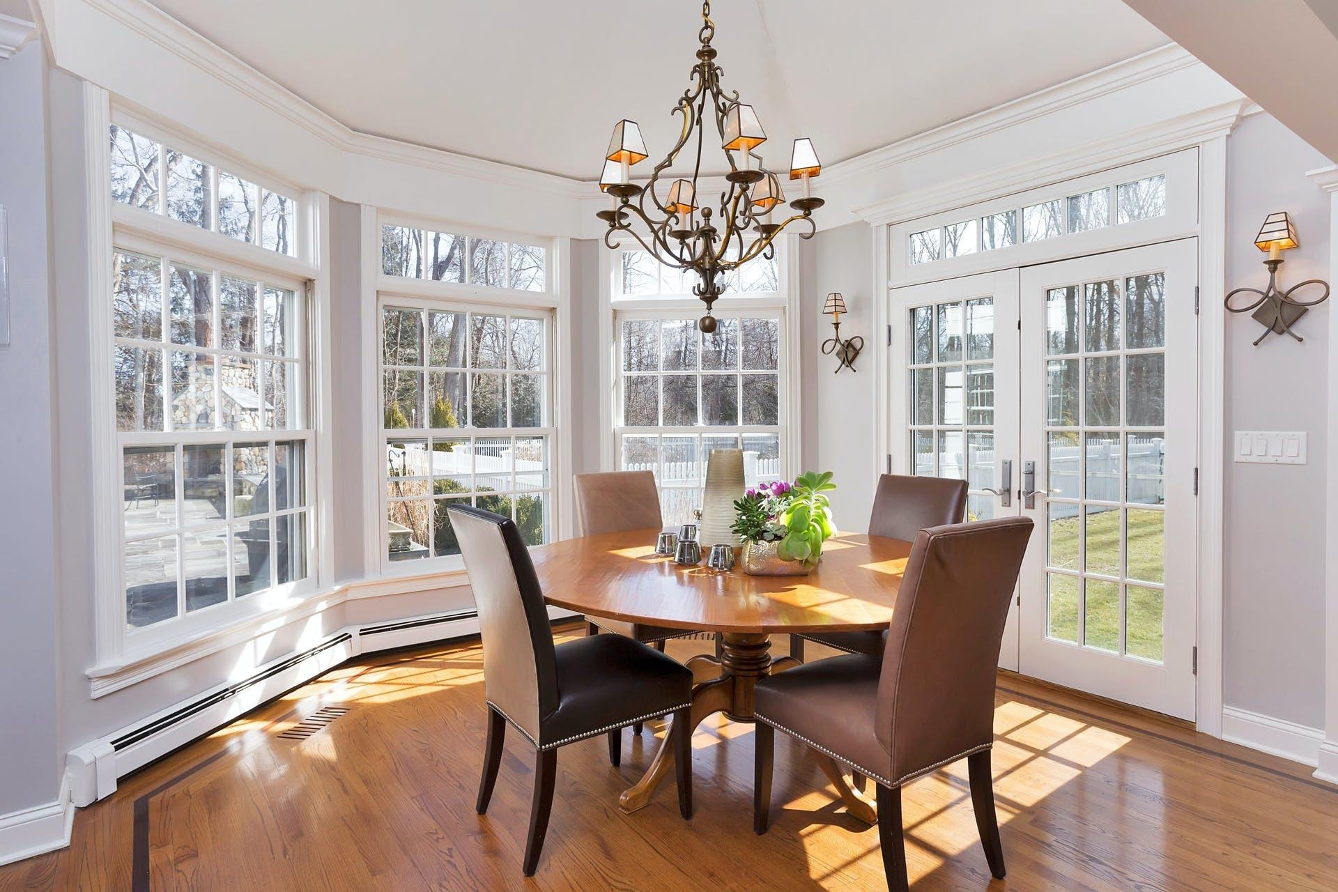 100 Stephen Mather Road Darien, CT 06820 - Photo 15 of 38 a view of a dining room with furniture a chandelier and wooden floor