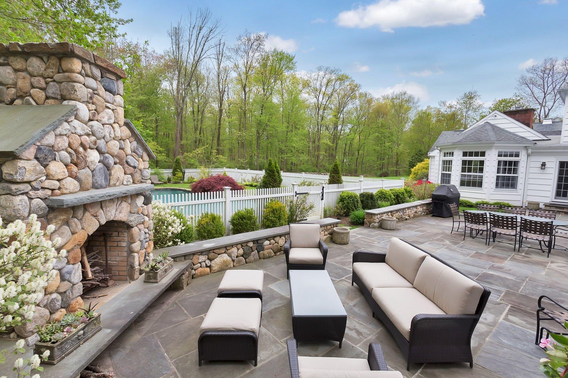 100 Stephen Mather Road Darien, CT 06820 - Photo 18 of 38 an outdoor space with patio fireplace and outdoor seating