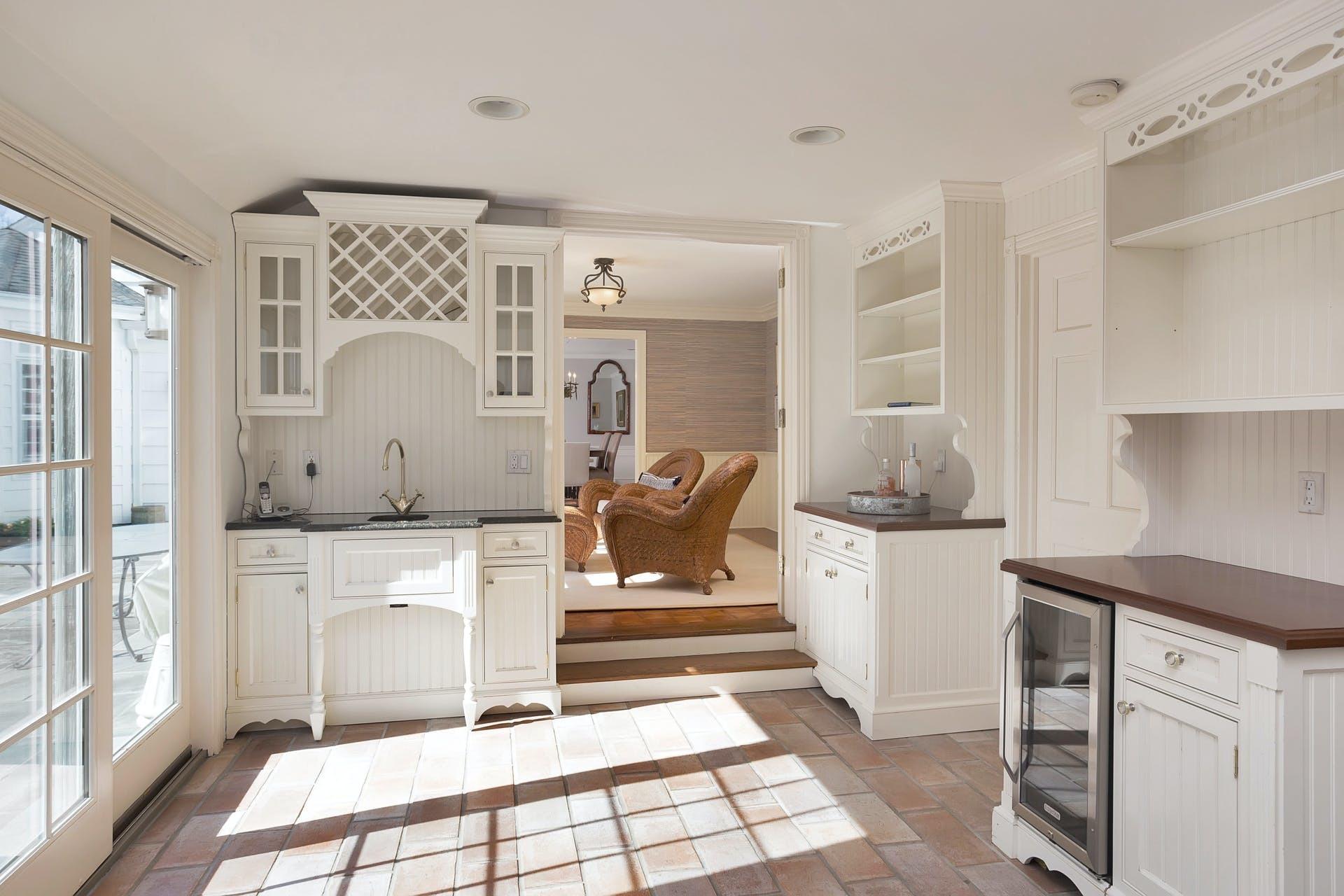 100 Stephen Mather Road Darien, CT 06820 - Photo 20 of 38 a kitchen with a refrigerator and white cabinets
