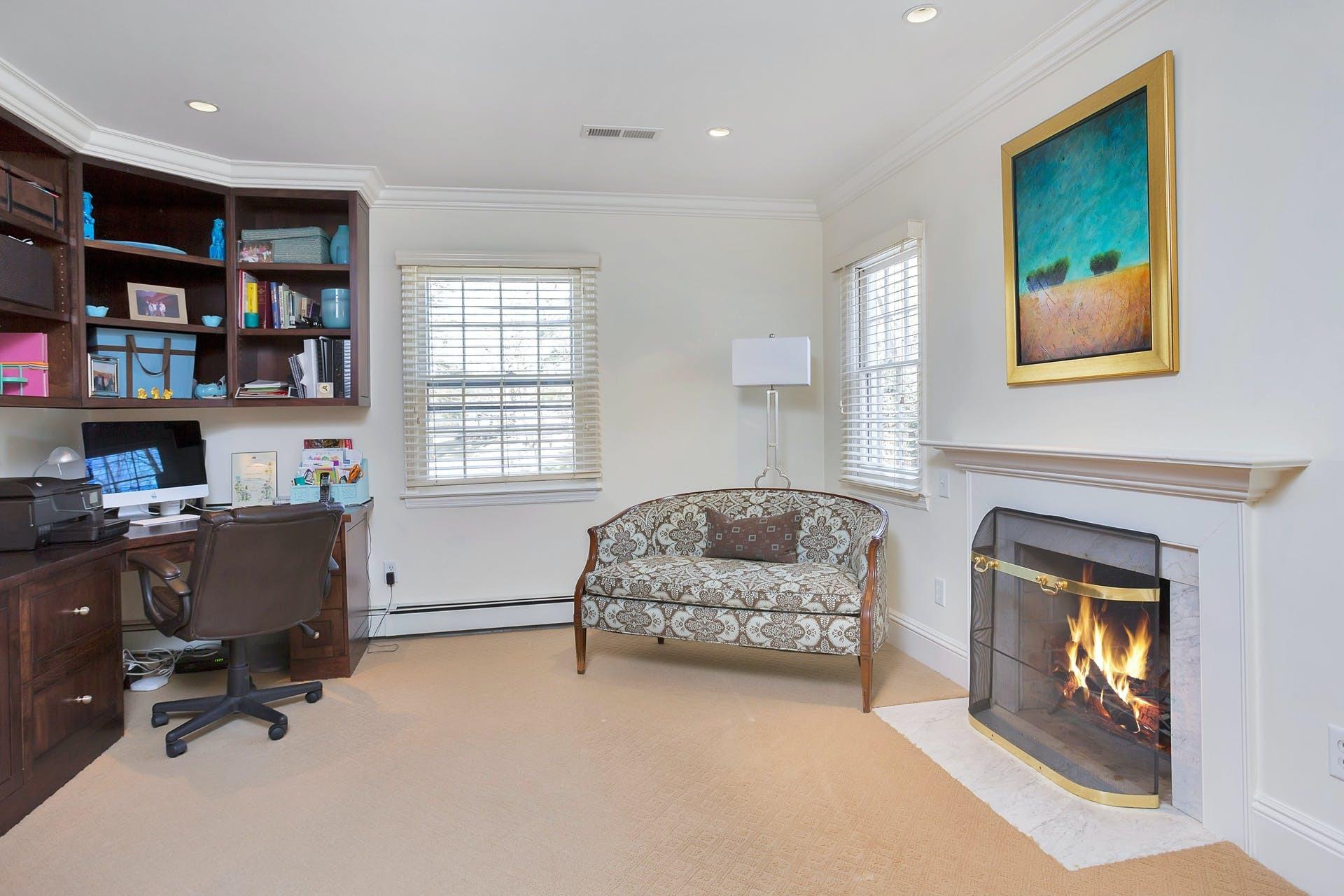 100 Stephen Mather Road Darien, CT 06820 - Photo 23 of 38 a living room with furniture and a fireplace