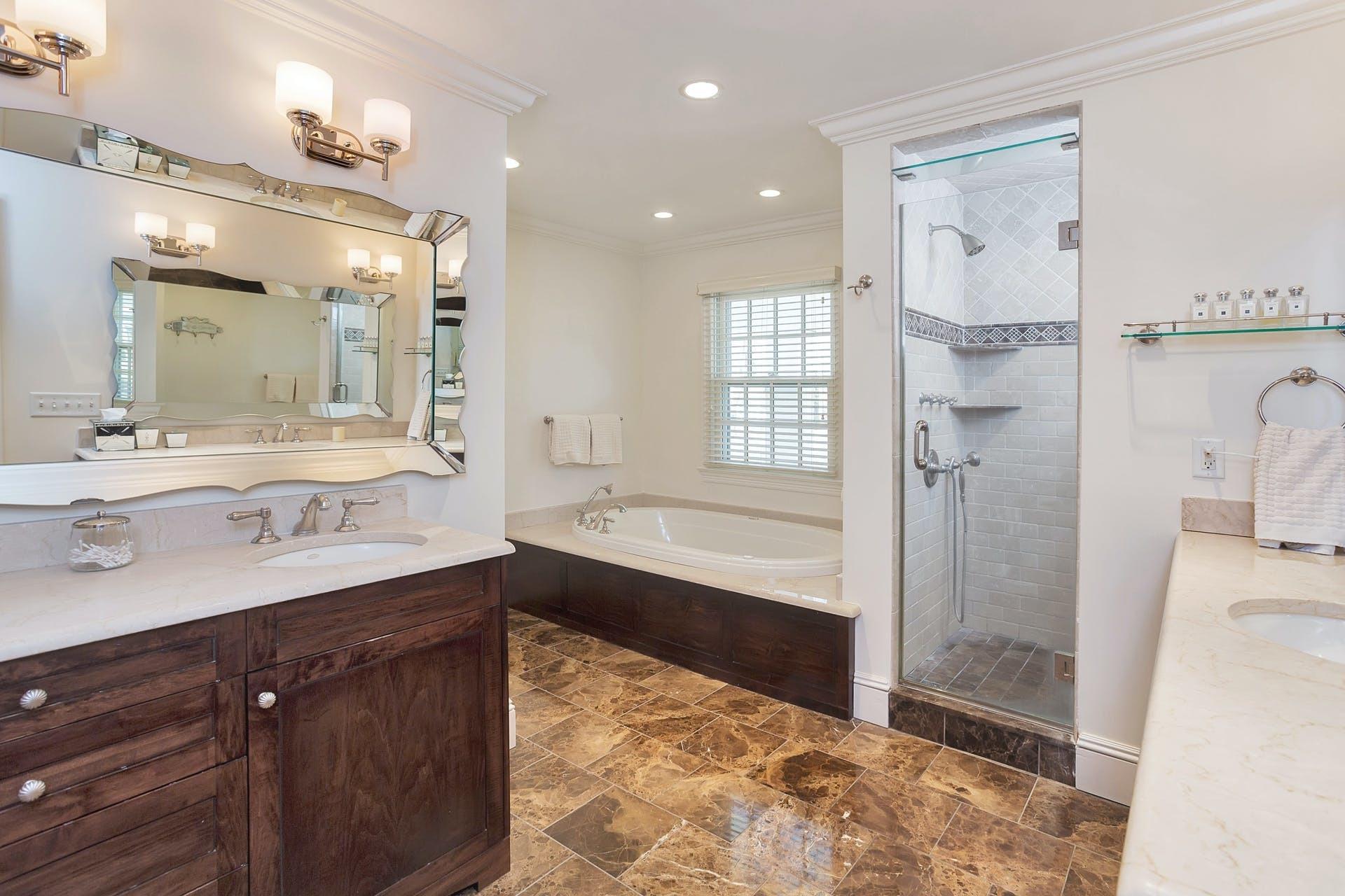 100 Stephen Mather Road Darien, CT 06820 - Photo 24 of 38 a bathroom with a bathtub shower sink double and mirror
