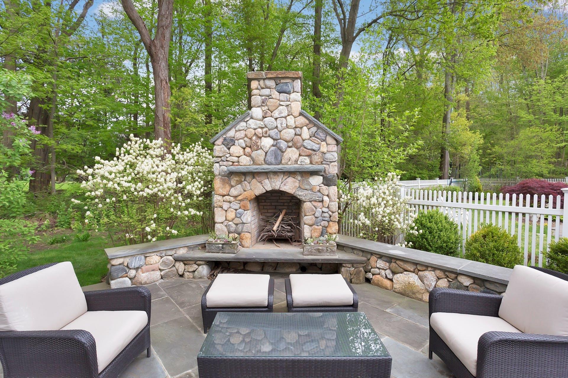 100 Stephen Mather Road Darien, CT 06820 - Photo 31 of 38 a view of a patio with couches table and chairs and potted plants